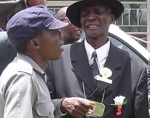 Headman Zihute chats to a junior police officer after the handover ceremony.