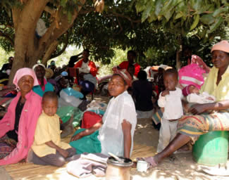 Displaced farm workers and their children seek shelter in the open
