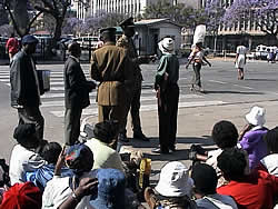Women seated in protest outside Parliament in Harare