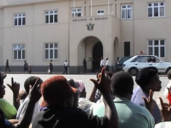 Women gather in protest against the NGO Bill, across the street from Parliament