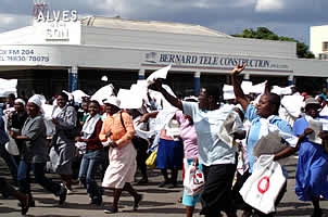 Members of WOZA march past Toppers Uniforms towards Mhlahlandlela calling for a reversal to the crippling school fee increases of up to 1000%